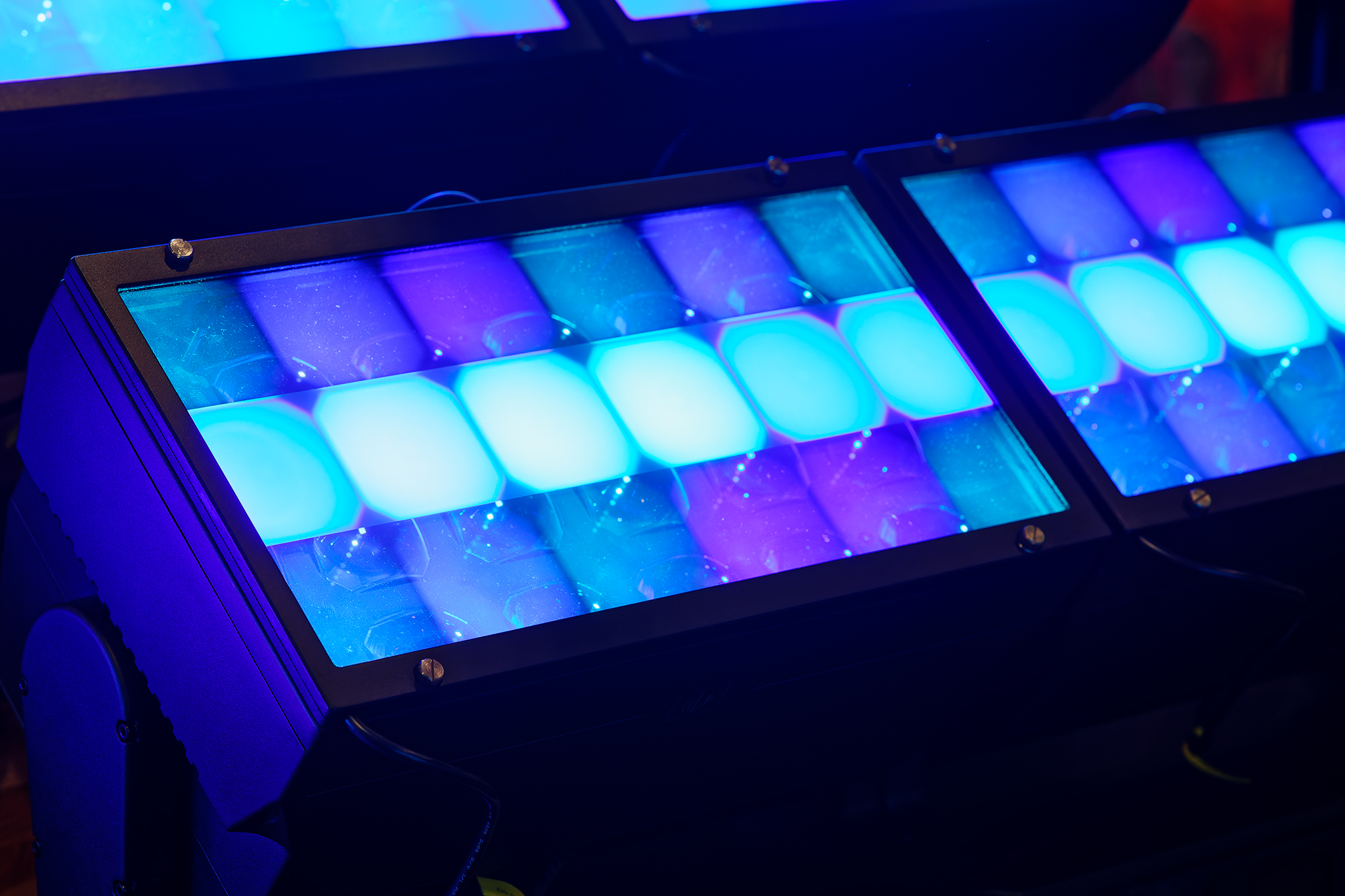 Cool toned light illuminated a dark room through frosted glass lens.